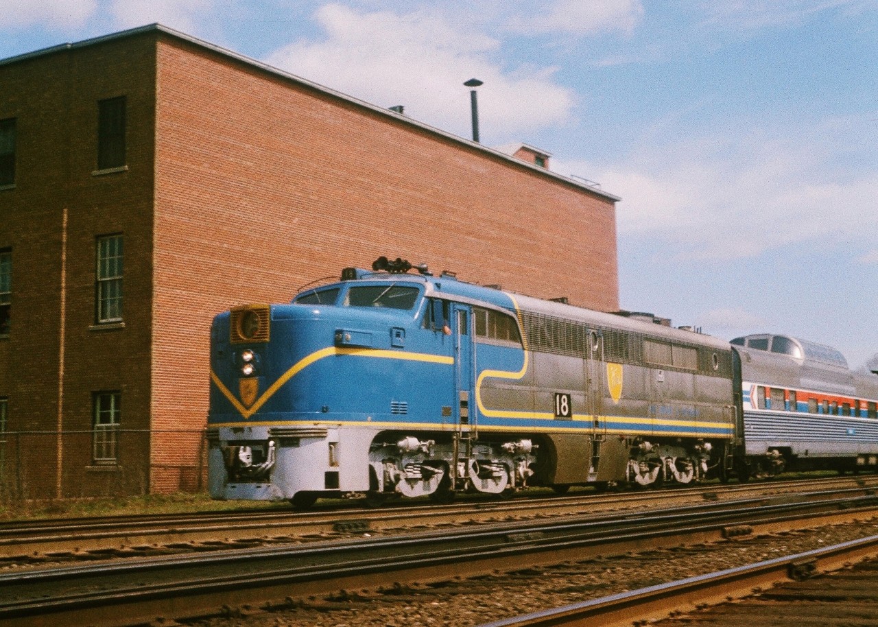 1976.


Olympic year.


Montreal.


The first ever Olympic Games held in Canada.


If EXPO67 was THE even of the Sixties, then the Montreal Olympics was THE event of the Seventies.


A real big deal.


Have to thank the Olympics for this  image * .


The pre Olympic construction boom in Montreal was unprecedented. Everything relating to construction was in short supply. Including construction equipment and vehicles. So much so that Toronto based truck rental and leasing businesses were paying chaps like me to drive brand new vans (built at the GM Scarborough Van plant – serviced by CN) to Montreal.


So, on a spring 1976 Saturday morning - after an overnight drive from Scarborough with a new white GM van as my wheels -  captured everyone's favourite passenger power:


ALCO P A-4 #18


In charge of Amtrak train #68 the Adirondack (dome car operated north of Mechanicville, N.Y.).


Classic sight: Delaware & Hudson (ex ATFS) livery. 


what more can I say? 


The D&H acquired ATSF PA-1's no. 16 to 19 in 1967. Rebuilt 1974-1975 by Morrison-Knudsen with 251V12 engines and re-designated as ALCO model PA-4


April 1976 pre-SLR Kodachrome at CP Rail  Westmount station, by S. Danko. 


Postscript: And in Toronto we had a cousin of the PA in our back yard for over two decades!
Imagine the RSD-17 in a cab car body: this is what THAT would have looked like!


Post Postscript: So why were the PA's in Amtrak service? * Have to thank, indirectly (and ironically), EMD due to problems Amtrak experienced with the new high-speed (100 m.p.h. Gearing (that's 162 k.p.h. In metric-eaze))  EMD SDP40F units (1973 – 1974). The SDP's developed a troubled reputation after reports of rough riding and several derailments blamed on its C-C trucks (which differed from EMD's freight C-C locomotives) causing the railroads over which Amtrak ran to impose speed limits starting in 1976-77.  The replacement units, the EMD F40PH (1975 - 1992) took several years to produce, so in the interim the first generation power ( EMD E-8's and these Alco PA's ) remained in service longer that originally planned. 


Post Post postscript: #18 is reportedly being restored to operating condition (with the  251V12 prime mover) as Nickel Plate #190 at the Oregon Rail Heritage Center.


(reference wikipeda)