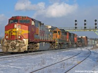 Having passed through town about five hours earlier on CN train 148, BNSF 794 now leads CN train 399, spelling for the ailing CN 5667 now trailing. A complicated series of moves, including wying the 794 and 399's power at Bayview Jct., were necessary to get it facing the right direction . With the aid of BNSF 6946, this train is now essentially all BNSF powered (the second one of the day). Cloud and snow squalls blew through all day long, but the two most interesting trains of the day were both greeted by sunshine here. 1636hrs.