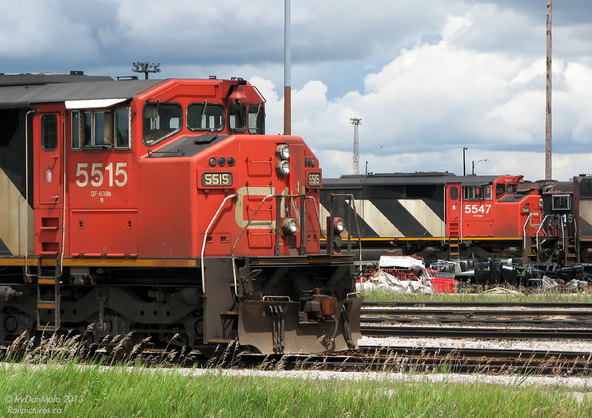 Laid off and out of work due to an economic downturn, CN 5515 and 5547 are just two of the dozens of locomotives stored at MacMillan Yard, coupled together and crammed onto every piece of available track around the diesel shop. They would eventually be put back to work, but for now sit parked together, unneeded by their owner.

Your daily lesson on locomotives: Both units pictured are SD60F models, a unique CN-only model derived from the standard SD60 and built by General Motors Diesel that featured a full-width cowl carbody with rear visibility tapering behind the cab, nicknamed the "Draper Taper" design (after William L. Draper, a CN Assistant Chief of Motive Power at the time). While other contemporary CN orders featured similar Draper Taper carbodies, it never really caught on en masse, and CN later reverted to more contemporary builder designs.
Class dismissed.