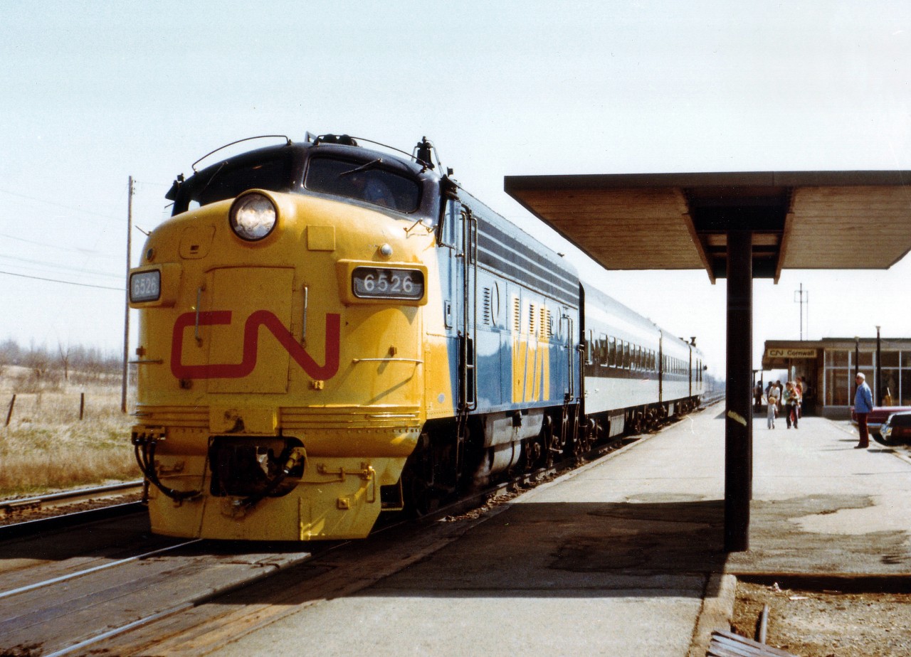 In the mid 1970s the passenger service in Canada was rather tattered. In order to improve service, CN offered up a new marketing slogan "VIA CN" complete with a fresh blue/yellow distinctive paint scheme. In January 1977 the government decided on a wholly owned subsidiary that would operate CN and CP passenger trains, which became effective in June as the new VIA RAIL Canada took over all the main passenger services in the country. March 31, 1978 VIA took over all CN pass. equipment, next day VIA became a Crown Corporation and in Sept of 1978 took over all CP passenger equipment. This image of mid-April 1977 of a westbound at Cornwall was my first sighting of the new paint scheme, and one of the very few seen with the "full dress" paint on the nose. This leaves me wondering which unit was painted first, and when.