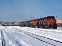 An eastbound CN freight rumbles through St. Henri with CN 2561, 2546, 2523, another M420 and a Central Vermont RS11.