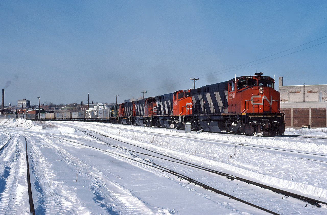 An eastbound CN freight rumbles through St. Henri with CN 2561, 2546, 2523, another M420 and a Central Vermont RS11.