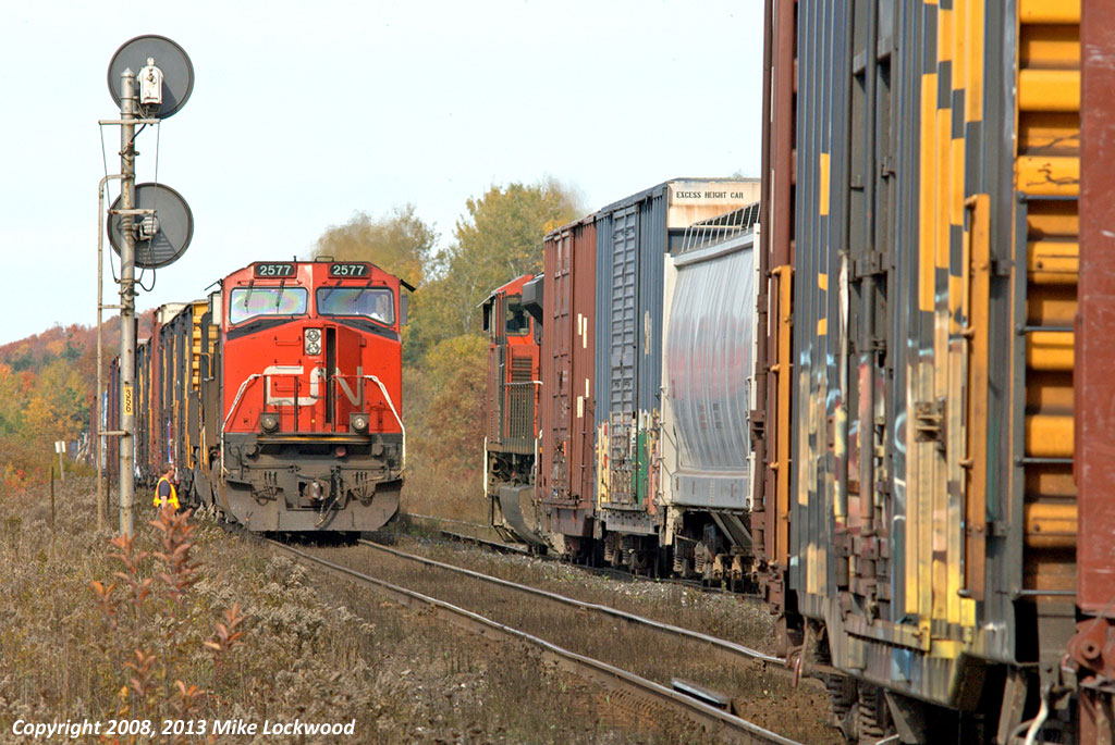 CN 451 pulls into the siding at Pine Orchard as 450 holds the main and gives a roll-by. That these are both CN's North Bay jobs and counterparts is fairly obvious by the presence of Ontario Northland cars on both. CN 2577 and NS 6627 head 450 while CN 8846 goes it alone on 451. 1407hrs.