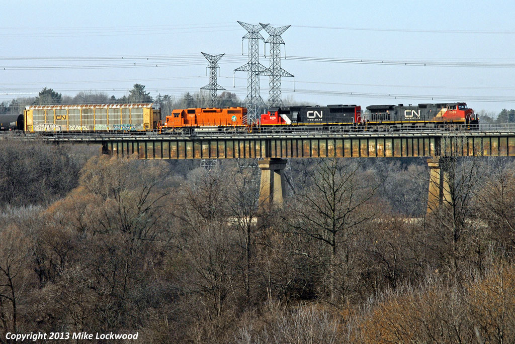Eastbound CN train 332 soars above the Humber River behind CN 2589, 5479, and EJ&E 674. Its been many years since I last shot here (think EcoRail for an idea of a time line), and apparently an EJ&E unit is what it takes to lure me back. Thank you Cam. 1402hrs.