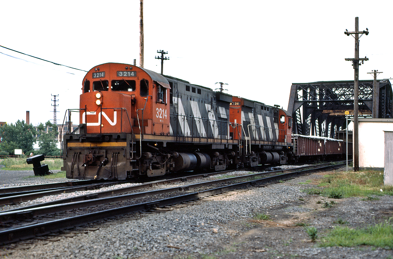 A pair of MLW C-424s (CN 3214 and 3228) lead a transfer through St. Henri on a muggy day in July 1984.  By 1989, all the C-424s will be retired from the CN roster with some being scrapped and others being sold to Mexican railways.