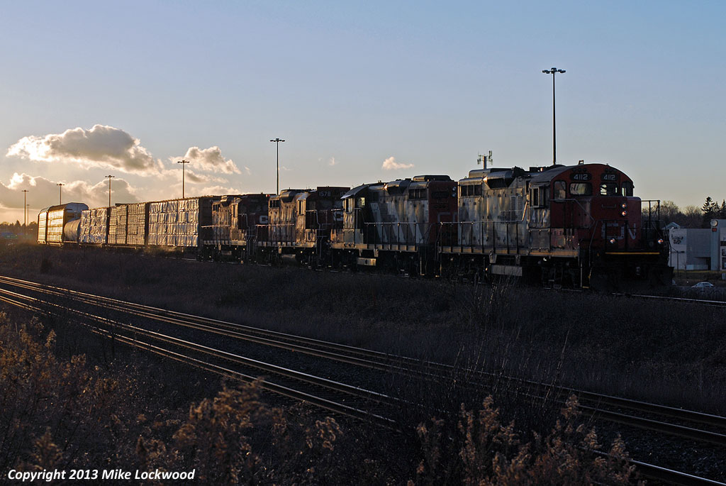Dropping down the York Sub, CN 570 is about to enter the Kingston Sub at Liverpool Jct. with a quartet of GP9's. CN 4112 and 4110 power the train, while CP 1578 and CP 1548 are dead in tow, on their way to Oshawa to be stripped and scrapped. Sunset on a cold and very windy day seems a fitting way to catch these two rolling what is likely their last few miles. Thanks Bill for the disposition information of the two GP9u's. 1618hrs.