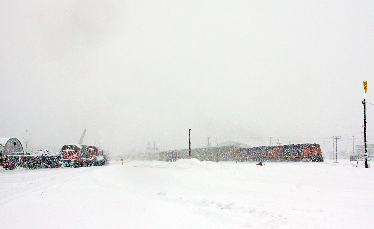 As the blizzard continues, CN 382 (CN 5793-2436 GTW 4626) scoops CN 509 on the north track as 509 continues to dig out the Walker's siding crossovers. CN 509 would normally be easily visible from this angle, but the big snowflakes made for poor visibility.