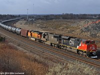 It's pretty rare for anything foreign coming up from Port Huron / Sarnia to get east of Mac Yard, beyond the exceptionally rare detour move, so the chance to shoot this train was a little too much to pass up. Bonus that I was already in Oshawa for business, and with a few text messages with some very timely information, I was able to bag this 710 crude train with very little loss of time indeed. It is worthy of note that the sight of a unit tank train on the Kingston Sub is rare, unlike CP's Belleville Sub, where I shot a 608 less than 25 minutes earlier. CN 8825, IC 1022, and BNSF 4011 provide the impetus for the train. 1409hrs.

BTW, take a close look at the rear of IC 1022... you can see the 'C' of the CN noodle that someone has applied to the rear. Every time you see IC font on a CN unit, think of IC 1022 and smile.