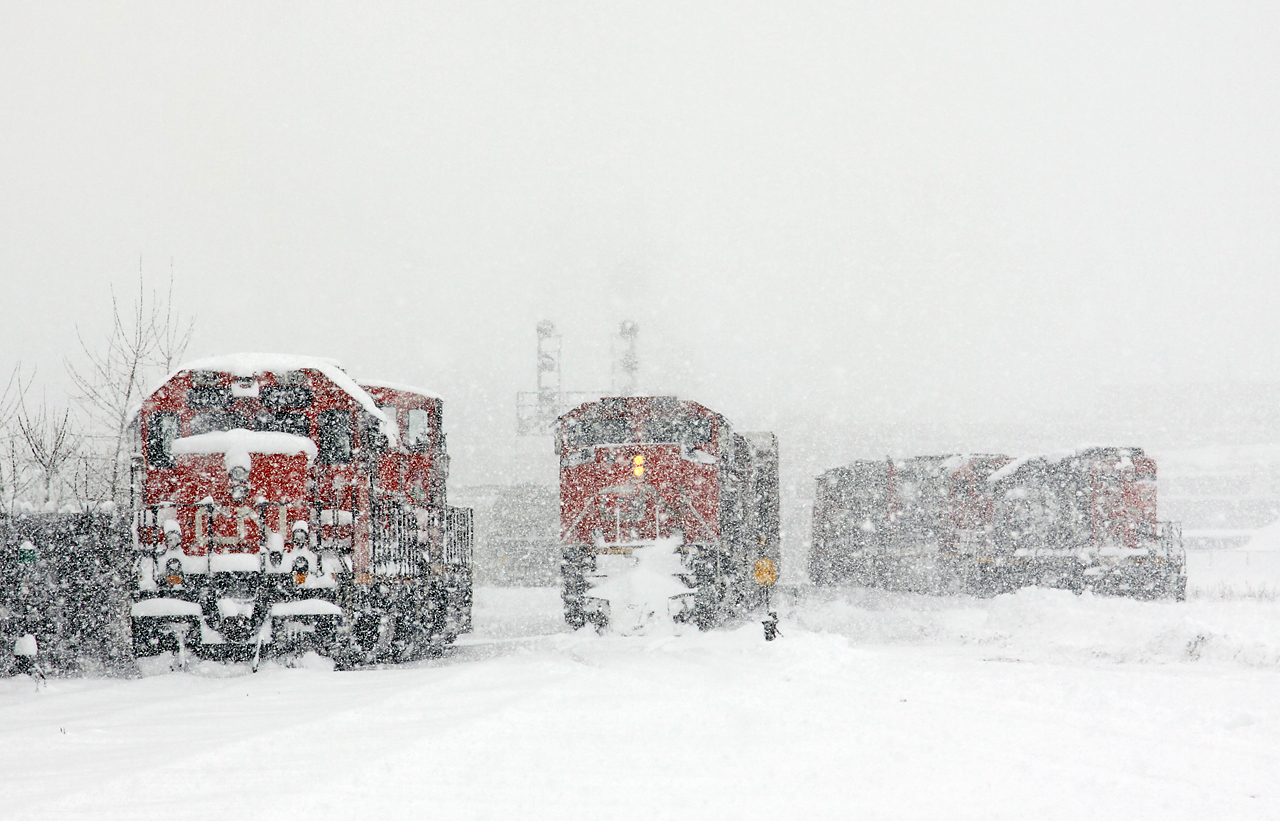 After spending at least the last half hour sweeping out the Walker's Siding/South track crossovers and derail (and tying up almost every crossing on the Dundas sub in London), a rather long CN 509 slowly pulls down the west lead into Racecourse yard while a very cold CN 4707-1412 try to keep warm on their day off. In the distance, CN 439 lifts CN 4116 off the shop track for transport to Chatham.