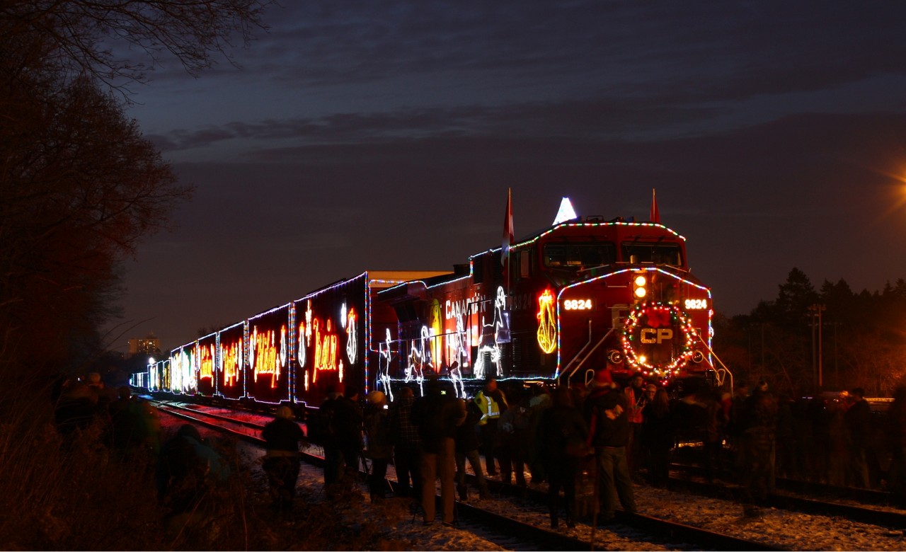 The CP Holiday train, having just arrived at Kinnear, still has a thick crowd around 9824, full of people getting up close and personal the train that rivals the Griswold’s house at Christmas time. You can probable pick out some fellow RailPictures photographs in this photo, including my brother Peter “The Snowman” MacCauley (referring to his snowy submissions from London last week) somewhere among the flashes and shutter-clicks of the jubilant Hamiltonian onlookers.