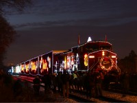 The CP Holiday train, having just arrived at Kinnear, still has a thick crowd around 9824, full of people getting up close and personal the train that rivals the Griswold’s house at Christmas time. You can probable pick out some fellow RailPictures photographs in this photo, including my brother Peter “The Snowman” MacCauley (referring to his snowy submissions from London last week) somewhere among the flashes and shutter-clicks of the jubilant Hamiltonian onlookers. 