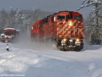 The sun has come out, however the snow has yet to taper off as a storm off Georgian Bay moves on, revealing a winter wonderland at CN's Waubamik siding. Utilizing directional running rights over CN's Bala Sub, CP 220 cruises south behind an SD40-2F and five SD40-2's, with about 11 miles separating it from home rails of CP's Parry Sound Sub at Boyne. Of the locomotives powering this train, CP 9002, 5763, 5984, 5925, 6037 and 5966, only two, 5763 and 6037, as of November 6, 2013 are still listed on the active roster. Sadly, the 9002 was retired less than two years after this shot was taken. 1451hrs.