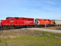 CP T29 led by new GP20C-ECO 2212 & GP38AC 3019, heads westbound past the Strong Road crossing as it approaches Belle River.