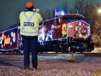 <b>Everyone wants to photograph the CP holiday train!</b> Even a CP police officer wants a shot of it.....This is the U.S. CP Holiday train, stopped at Delson, Quebec. For more train photos, check out http://www.flickr.com/photos/mtlwestrailfan/
