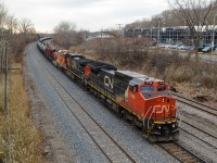 CN U710 (loaded oil train) is heading east through Ville St-Pierre on the island of Montreal. Lead engine is an ex-BNSF Unit (CN 2146), second unit is CN 2558 and third unit is BNSF 6584 (a fairly new GE ES44C4). BNSF units in Montreal are almost unheard of but will probably become more common with the upswing in CN oil trains. For more train photos, check out http://www.flickr.com/photos/mtlwestrailfan/ 