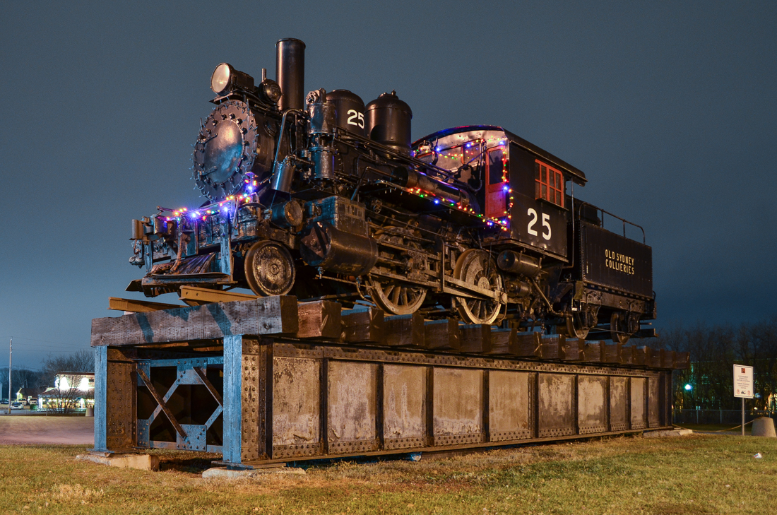 At the entrance to Exporail. After photographing the CP Holiday train nearby, I figured I would try a night shot of this unique steam engine as it has a small amount of Christmas lights. This steam engine was built by Baldwin in 1900 as a 2-4-0T called E.E. Bigge for Nova Scotia Steel & Coal and was not retired until 1962. For more train photos, check out http://www.flickr.com/photos/mtlwestrailfan/