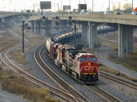 CN U710 (loaded oil train) departs eastwards after changing crews at Turcot West. Lead engine is an ex-BNSF Unit (CN 2146), second unit is CN 2558 and third unit is BNSF 6584 (a fairly new GE ES44C4). BNSF units in Montreal are almost unheard of but will probably become more common with the upswing in CN oil trains. To the left is a spur which leads to Canadian Allied Diesel in Lachine, up until the early 1960s that was CN's main line to points west of Montreal. For more train photos, check out http://www.flickr.com/photos/mtlwestrailfan/ 