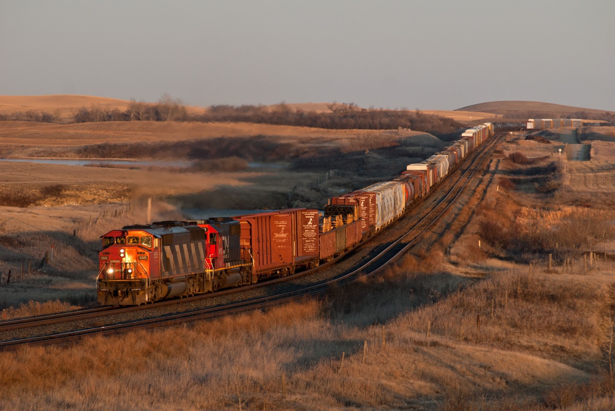 In the very last rays of daylight, 5515 and IC 6113 lead 301 past the siding at Neola.