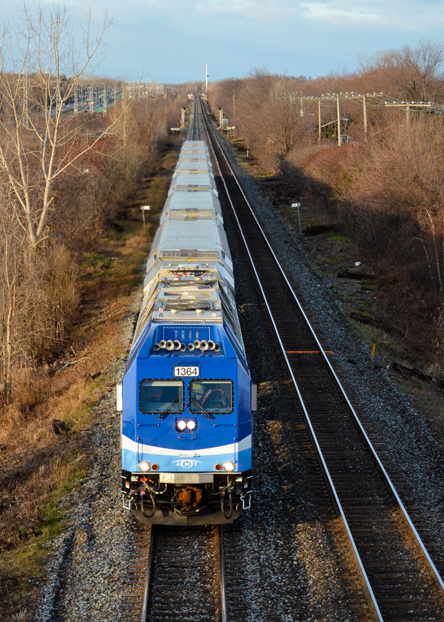 During a brief period of sunshine, AMT 1364 leads an inbound commuter train (AMT 16) on the Vaudreuil/Hudson line during the morning rush hour on a truly frigid morning. Leading is dual mode engine AMT 1364, operating exclusively in diesel mode for its entire run. For more train photos, check out http://www.flickr.com/photos/mtlwestrailfan/
