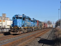 A short 431 with just 14 cars is easy work for this SD trio. At left, empty tracks and platforms await the arrival of the afternoon GO trains. The building in the background is the former Alliance Paper Mill. Built in 1910 as the Georgetown Coated Paper Mill, it was one of two rail-served mills that once operated here. It shut down in 1977.