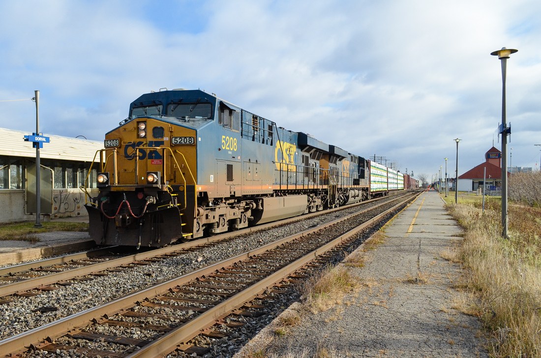 CSX 5208 & CSX 908 head west through Dorval with CN 327. For more train photos, check out http://www.flickr.com/photos/mtlwestrailfan/