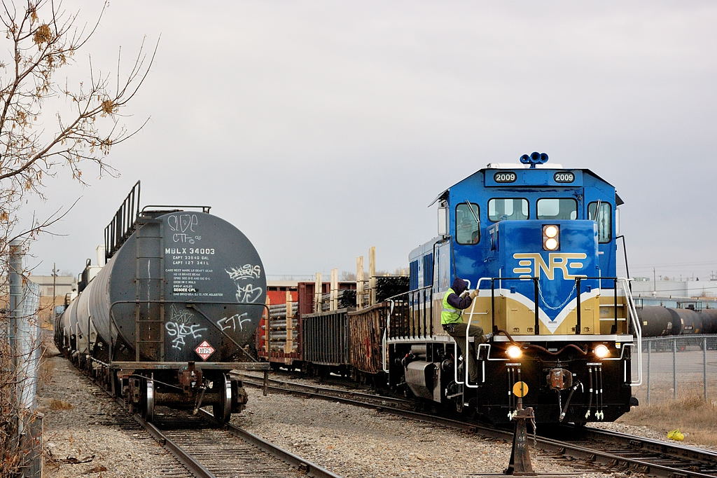 NREX's 3GS21B demo 2009 works the industrial area around Ogden for CP. The crew member has lined the switch in the foreground and will head up to the mainline to head towards Alyth and/or Ogden yard.