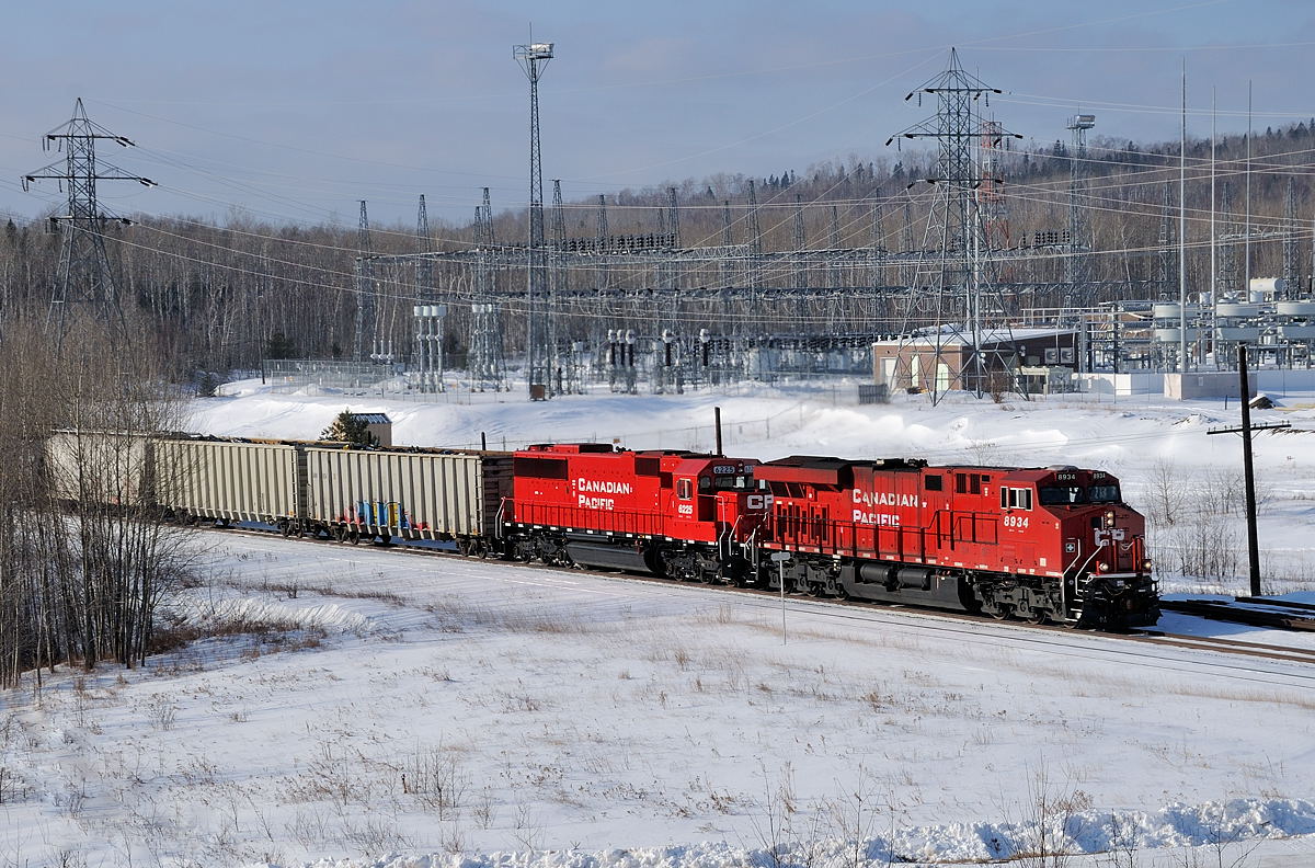 Thunder Bay to Toronto freight 220 departs Thunder Bay working its way upgrade past the Hydro One power station at Navilus with new ES44AC 8934 and newly refurbished SD60 6225 (ex SOO 6025).