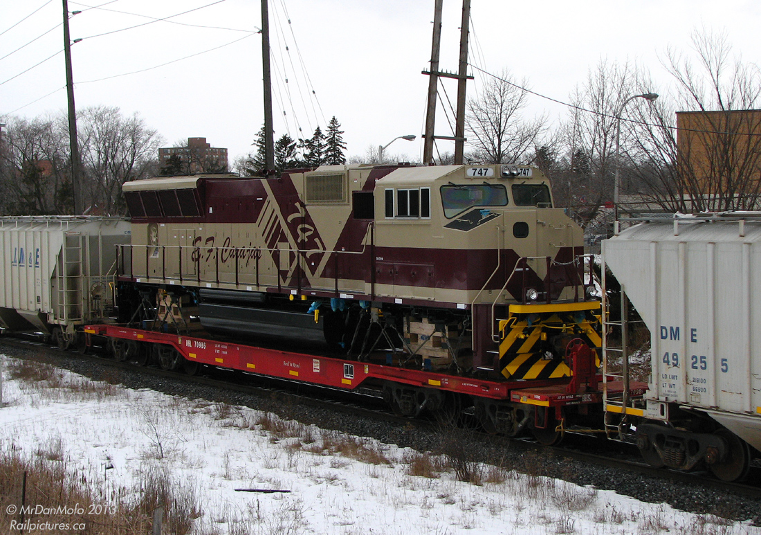 A good source of intel is always a treat, and makes catching the goodies so much easier. Try as I might, whenever they shipped these particular export locos out from the factory for forwarding to the port it was either cloudy or snowy, and sometimes both.   But trailing on GEXR #432 this cloudy day was one of them: E.F. Carajas 747, an EMD SD70M, heading to its new owner in Brazil. Due to the different gauge track in Brazil, it was necessary to mount the locomotive on a heavy-duty flatcar (8-axle KRL 70986 in this shot) instead of moving it on its own wheels over North American trackage.  According to sources, these units were part of an order numbered 728-755, built by EMD in London, Ontario Canada for mining company Companhia Vale do Rio Doce in Brazil (CVRD, the company, is now part of giant VALE) to operate on their railroad Estrada de Ferro Carajás ("E.F.Carajas"). The photographer shot the first 6 units of the order in transit December 13th 2006, and missed the last unit as it went under his GO bus on Airport Road, March 27th 2007.