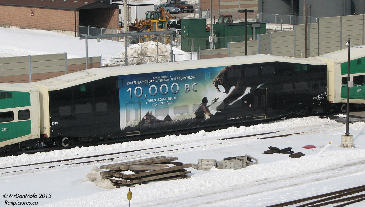 Sitting in GO Transit's Willowbrook Yard surrounded by hundreds of green and white passenger cars, GO 2313 dares to be different, sporting a wrap for the movie 10,000BC.