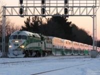 It was a cold and nippy Sunday to go foaming, but there was quite a bit to see. CN freights, SOR power parked for the weekend in Hamilton, the VIA's, and of course weekend GO's on the Lakeshore Line.
<br><br>
But that day the GO's were far from the usual: weekends meant double-header F59PH's hustling back and forth from Aldershot to Oshawa, and at the time the first few brand new MP40PH-3C's were operating in break-in service with an F59PH. After shooting this train idling at Aldershot GO Station with brand new GO 605 leading (and running out of batteries right after - the spares were in the car), a short trip east put two railfans at the King Road level crossing near CN's Aldershot Yard, and with a fresh set of batteries the wait was on for it to depart with the new MP40 in the lead. And so it was captured: with the pink glint of a winter sunset just past 6pm, GO 605 leads venerable F59PH 525 on train #926, after departing for its run east minutes earlier. Its pilot and lower front end are encrusted in a layer of frozen snow, no doubt from ping-ponging back and forth along the line all day.
<br><br>
An interesting note is when the MP40's were new, a lot of engine crews forgot to turn off the marker lights if the unit was trailing before, resulting in running forward with both headlight and marker lights on on the same end.