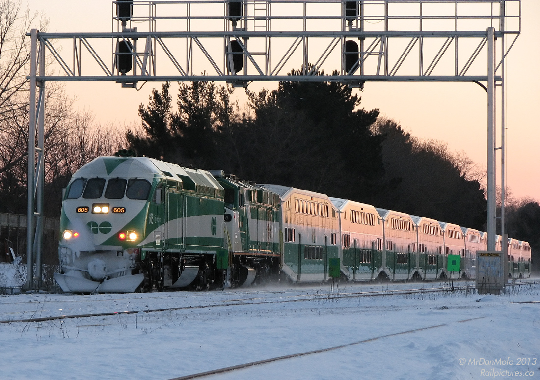 It was a cold and nippy Sunday to go foaming, but there was quite a bit to see. CN freights, SOR power parked for the weekend in Hamilton, the VIA's, and of course weekend GO's on the Lakeshore Line.

But that day the GO's were far from the usual: weekends meant double-header F59PH's hustling back and forth from Aldershot to Oshawa, and at the time the first few brand new MP40PH-3C's were operating in break-in service with an F59PH. After shooting this train idling at Aldershot GO Station with brand new GO 605 leading (and running out of batteries right after - the spares were in the car), a short trip east put two railfans at the King Road level crossing near CN's Aldershot Yard, and with a fresh set of batteries the wait was on for it to depart with the new MP40 in the lead. And so it was captured: with the pink glint of a winter sunset just past 6pm, GO 605 leads venerable F59PH 525 on train #926, after departing for its run east minutes earlier. Its pilot and lower front end are encrusted in a layer of frozen snow, no doubt from ping-ponging back and forth along the line all day.

An interesting note is when the MP40's were new, a lot of engine crews forgot to turn off the marker lights if the unit was trailing before, resulting in running forward with both headlight and marker lights on on the same end.