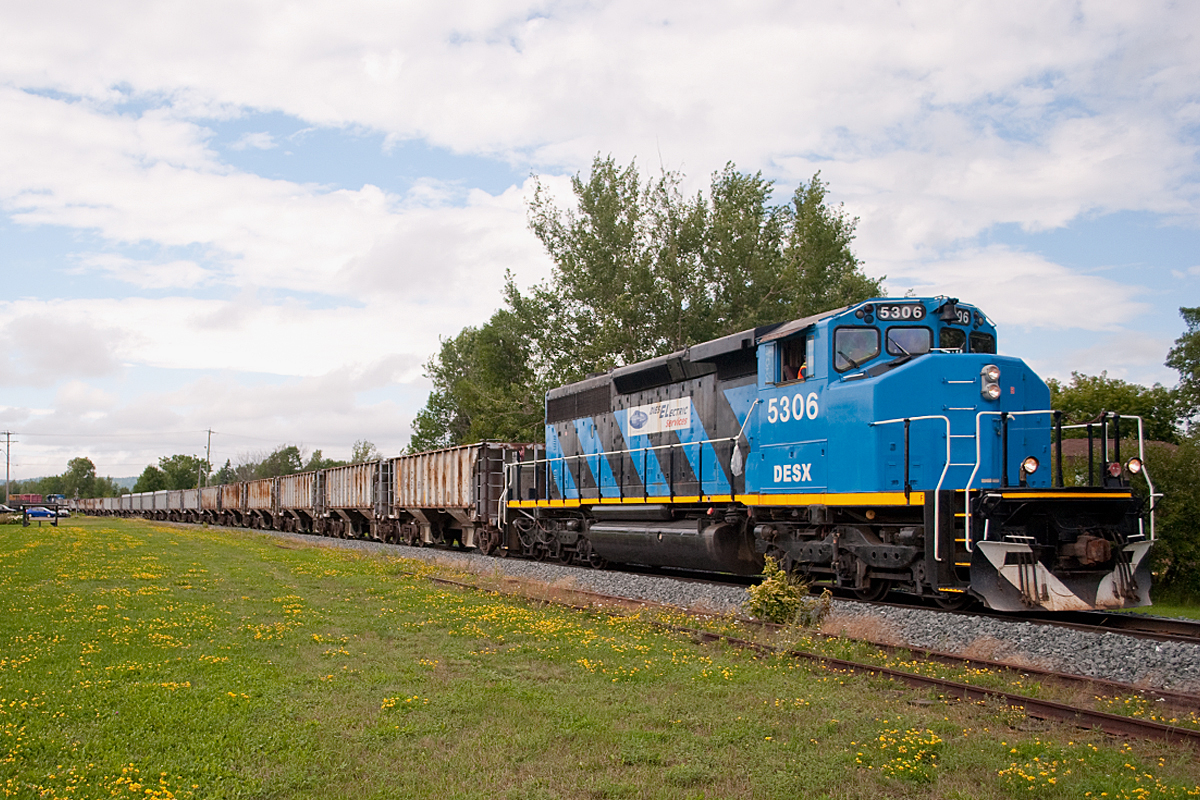 Passing through the tiny hamlet of Echo Bay, this eastbound ballast train deadheads for an overnight rest in Blind River. They ran this train using an "L20L setup, with an identical DESX 5309 shoving on the tail end.