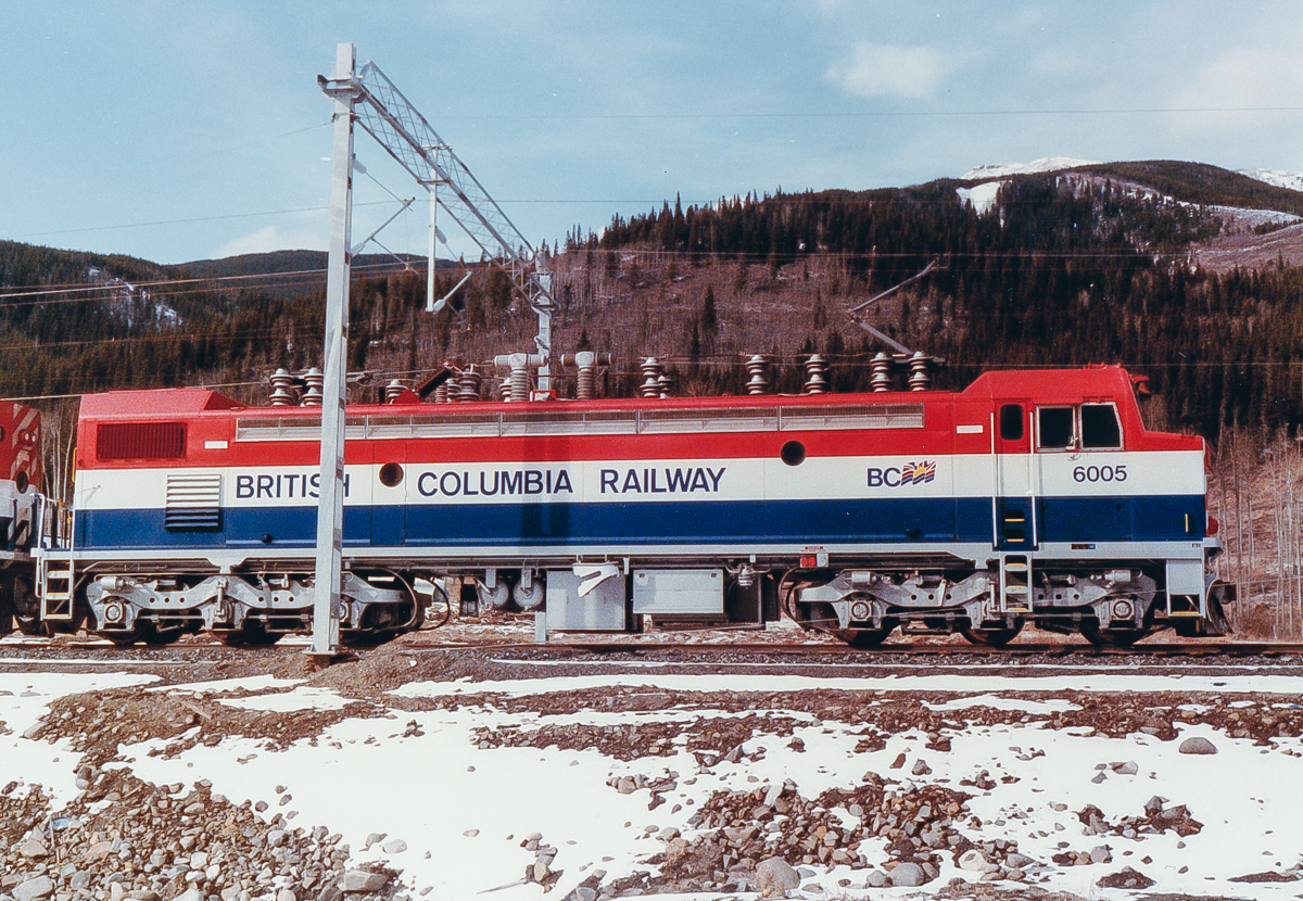 Photo taken by Glen Fisher, my father-in-law. He is is a railway consultant and was involved in the BC Rail Tumbler Ridge electrification during the early 1980s. This shot shows one of the GF6C locomotives before regular service on the line began. All have since been retired and the line deelectrified. Unknown location, please let me know if you have information on the exact location.