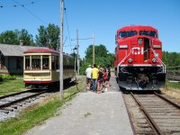 For the 50th anniversary of Exporail in 2011, CP sent a freshly repainted locomotive (CP 9733) to the musuem and opened the cab up to the public. Here people line up for a view of the cab as MTC 1959 passes to the left. Behind is Barrington Station. For more train photos, check out http://www.flickr.com/photos/mtlwestrailfan/