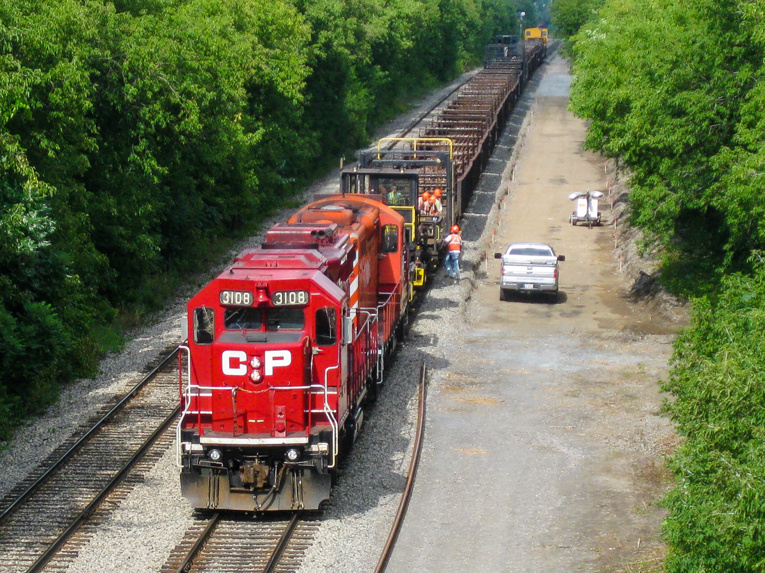 A CP rail train is laying down ribbons of continuous welded rail on CP's Westmount Sub, which normally only sees AMT passenger trains. The power is CP 8231 & CP 3108, and non-graffitied, multimarked van 434957 is on the rear. For more train photos, check out http://www.flickr.com/photos/mtlwestrailfan/