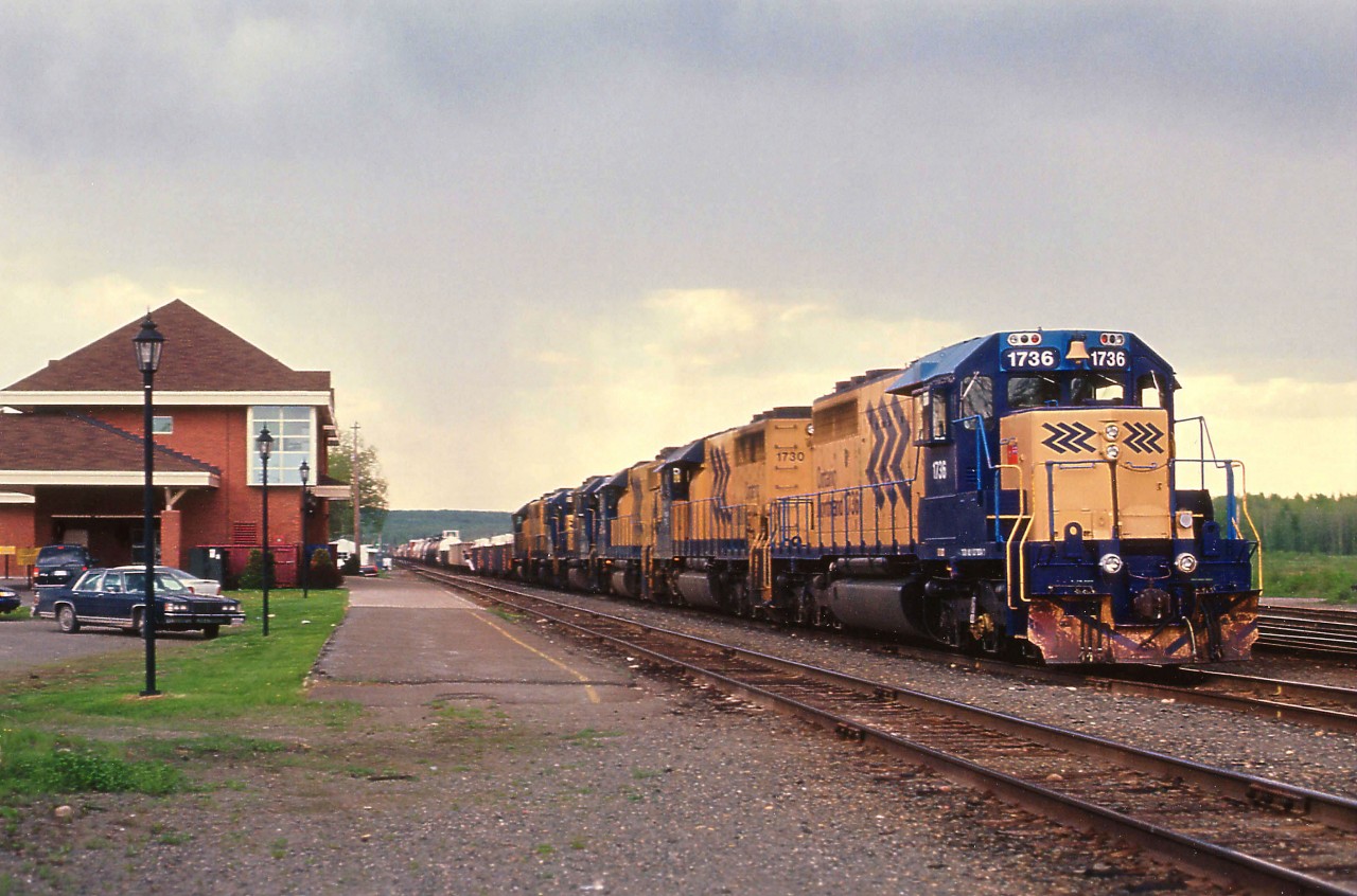 The daily Englehart south to North Bay train was much more photogenic before those new SD75I locomotives came on the scene in late 1999.  Here we see the train getting ready to depart Englehart station late on a cloudy afternoon June 5, 1997; with ONR 1736, 1730, 1804, 1802, 1800 and 1806 up front. (Two SD40-2s and 4 GP38-2s)
**Does anyone know why the old white-sided station was replaced and when?