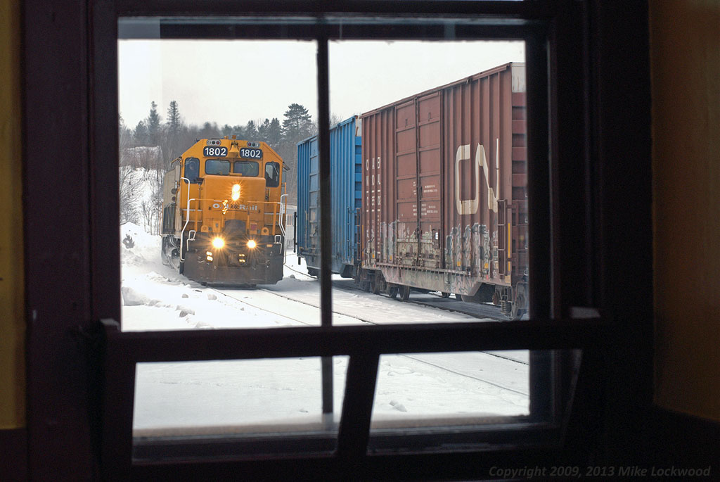 The southbound Northlander pulls into the station at Huntsville alongside the cars of recently arrived CN 595. A snowy and cold winter's day on the railroad just after Christmas, its nice and warm inside the station. Unknown at the time, this would not be repeatable in less than three years. 1214hrs.