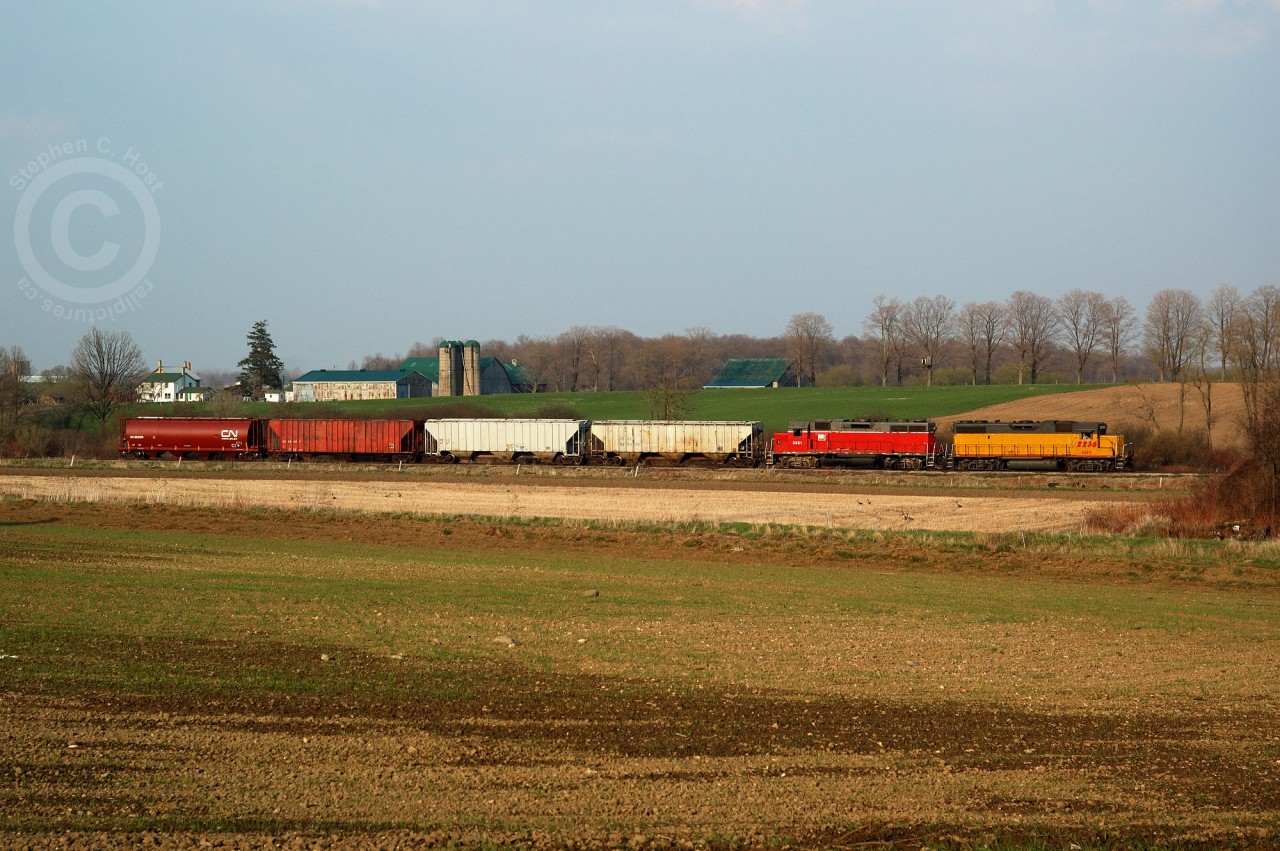 GEXR 582 is backing towards Elmira to unload four cars of Fertilizer.  In a rare move, earlier that evening 582 brought 16 cars of fertilizer north from Kitchener, set off 12 cars in the siding at Waterloo, and ran around these 4 cars for the 10 mile shove to Elmira. This railway was and is still dominated by chemical tank cars, for Chemtura and Sulco Chemicals both in Elmira and receive 5 day a week service. The only other customers on this line are Home Hardware at St. Jacobs, and Commonwealth Plywood in Waterloo who both receive infrequent service. More interesting points: The Region of Waterloo owns the line and saved it from abandonment, and CN (!)is contracted to maintain signals and track on the Waterloo spur, despite GEXR providing freight service.