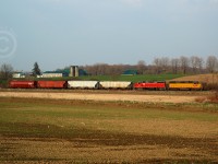 GEXR 582 is backing towards Elmira to unload four cars of Fertilizer.  In a rare move, earlier that evening 582 brought 16 cars of fertilizer north from Kitchener, set off 12 cars in the siding at Waterloo, and ran around these 4 cars for the 10 mile shove to Elmira. This railway was and is still dominated by chemical tank cars, for Chemtura and Sulco Chemicals both in Elmira and receive 5 day a week service. The only other customers on this line are Home Hardware at St. Jacobs, and Commonwealth Plywood in Waterloo who both receive infrequent service. <br><br>More interesting points: The Region of Waterloo owns the line and saved it from abandonment, and CN (!)is contracted to maintain signals and track on the Waterloo spur, despite GEXR providing freight service.