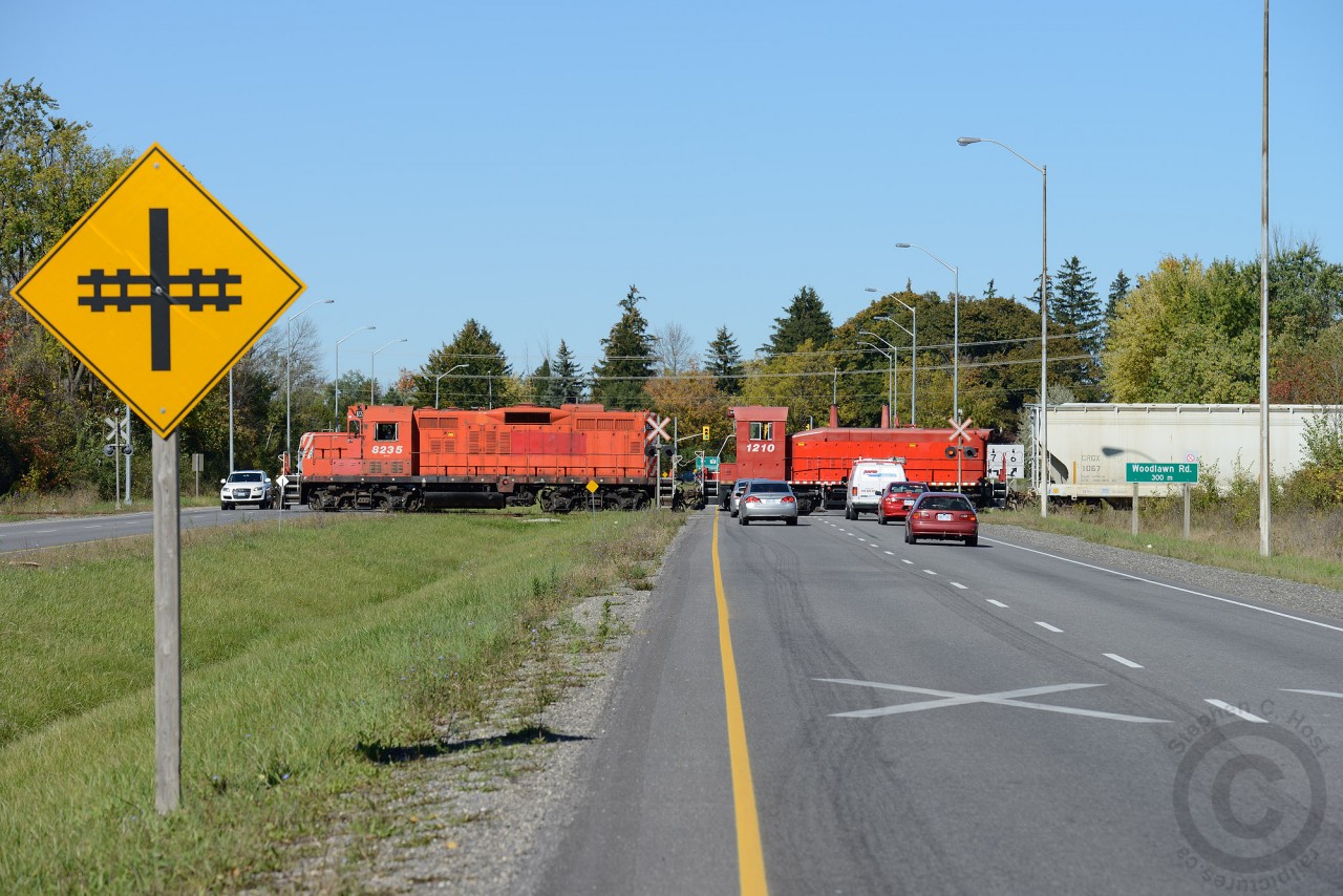 Ontario Southland Railway backing their train across Highway 6/7 in Guelph, also known as the Hanlon Expressway. In a few years this highway should be extended directly north to connect to Highway 85 in Kitchener, and it is expected this crossing will be closed and the at-grade crossing behind the photographer will be turned into an overpass.
Trains crossing 'divided highways' are rare - and in 1969 the Railway built two spur lines (South and North Industrial) months before the Ministry of Transportation of Ontario decided to build a highway/bypass of Highway 6 through Guelph. New at-grade crossings like this would never be permitted today without an underpass/overpass. Do any railpictures.ca viewers have photos of Trains crossing divided highways at grade?