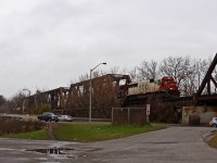 (editors note: one of the last soo paint on a quickly declining roster) One of the last remaining SOO SD60's (6035) brings CP 240 down the hill and across the bridge over the Thames River. Adhering to Murphy's law, why does it seem the good stuff always shows up in lousy weather? Regardless, it was still a neat catch.
