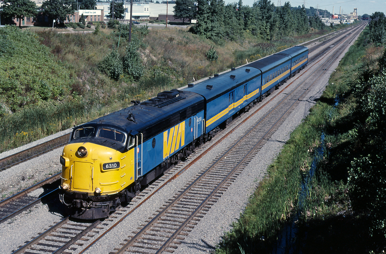 VIA 133 rolls through Ballantyne with an eclectic consist, VIA 6310, a baggage car and two coaches