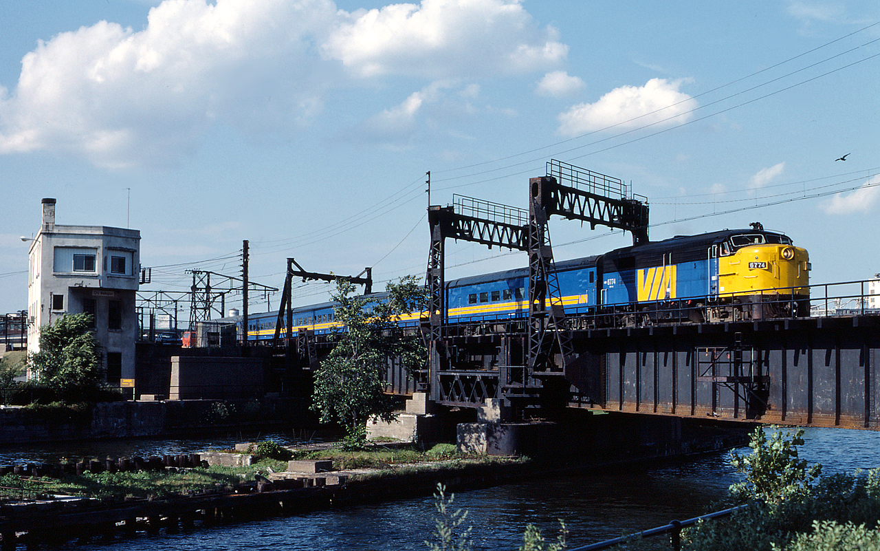 VIA 24 led by FPA-4 6774 crosses the Lachine Canal at Wellington on a beautiful summer day.