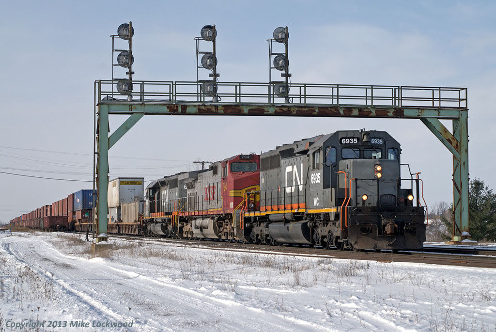 After completing some non-rail related diversions, the first train of the day was a pretty good omen of what was to follow. I've never before, or since, had such a good or busy day on the Dundas Sub. To get things going, WC 6935, BNSF 794, and WC 6936 lead 148 through Paris Jct., and would soon be called on to drop the BNSF unit off at Brantford to help train 399 that had lost one of it's two units. 1141hrs.