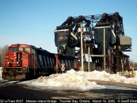 Empty coal train #337, with CN 5552 and 5425 for power, rolls over the Mission Island bridge with it's train of hoppers as it starts it's trip back west to load.  337 had unloaded at the Ontario Hydro generating plant on McKellar island.  In all my trips to Thunder Bay for work this was the only time I was lucky enough to catch a train coming off the islands.