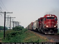 SOO LINE SD60 #6011 and a lone GE have an eastbound rolling fast through the flat land of Essex County on an early July day in 2005.