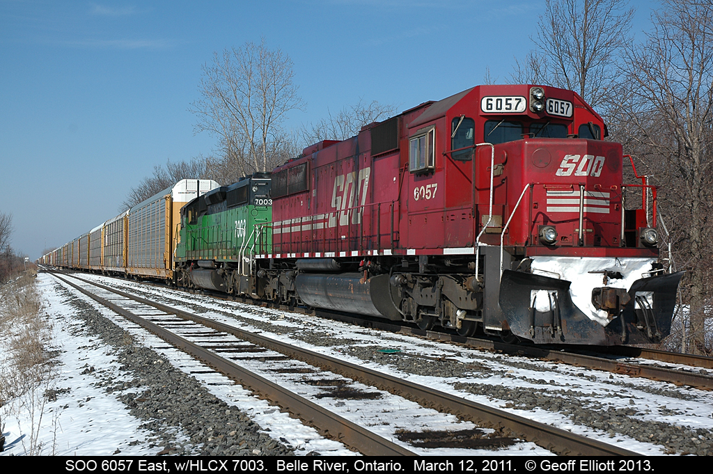 Since there have been a lot of posts of CP 6257 lately here is the "pre-rebuild" version.  SOO LINE 6057 and HLCX 7003 are tied down in the siding in Belle River, Ontario waiting on a crew.  This seemed to be a regular practice for a while as they would be eastbound trains to Belle River and park them for up to 2 days waiting on a crew.  Never found out why they did this.