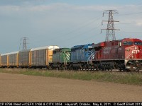 CP 8796, CEFX 3166, and CITX 3054 have this westbound well in hand west of Haycroft, Ontario back on May 6, 2011.  Late afternoon light is almost straight down the tracks, but is enough to show off this colorful lashup scooting across the Essex County flatlands.