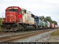 SOO LINE 6030, with it's non-standard italic name on the nose, has HLCX Leasors 8163 and 7230 trailing as they ready to depart Belle River siding having waited on the eastbound in the distance to clear.