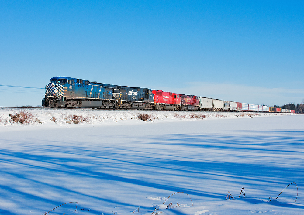 After setting off a car at Hornby with hot wheel problems due to a broken slack adjuster, this stellar lash up on CP 243 crosses the Mountsberg causeway on this cold winters day.